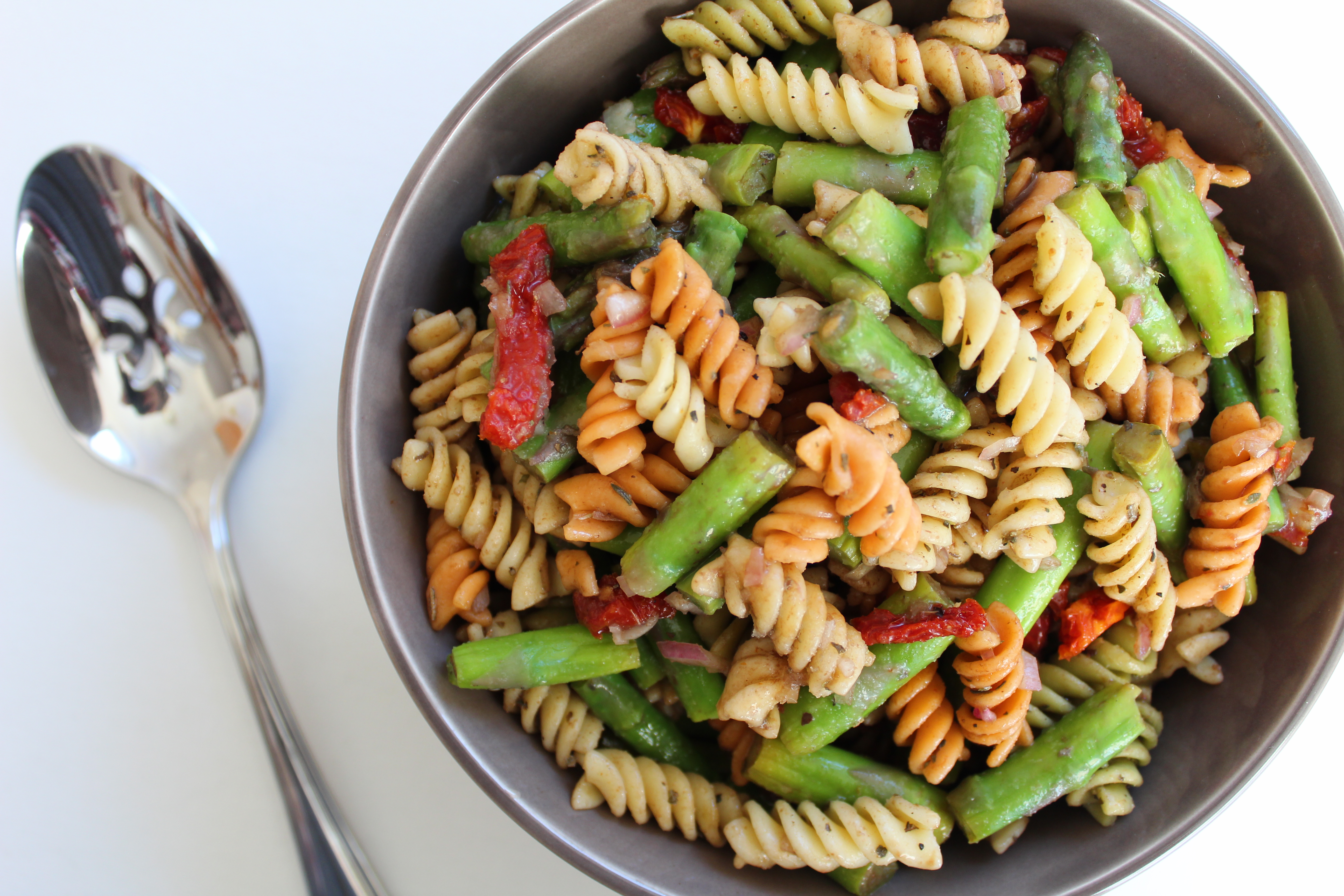 This fresh and bright pasta salad made with blanched asparagus, sun dried tomatoes, and a simple balsamic vinaigrette is perfect for an easy side dish or a simple lunch!